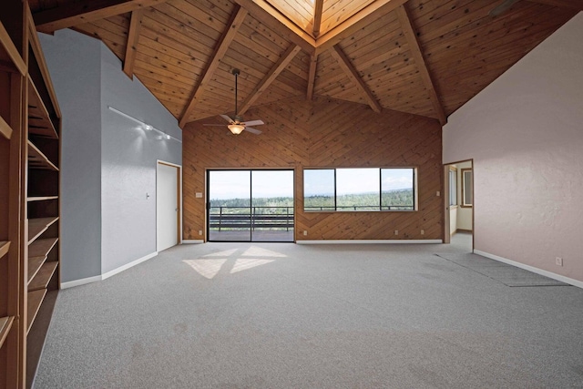 unfurnished living room featuring ceiling fan, beamed ceiling, carpet, high vaulted ceiling, and wooden ceiling