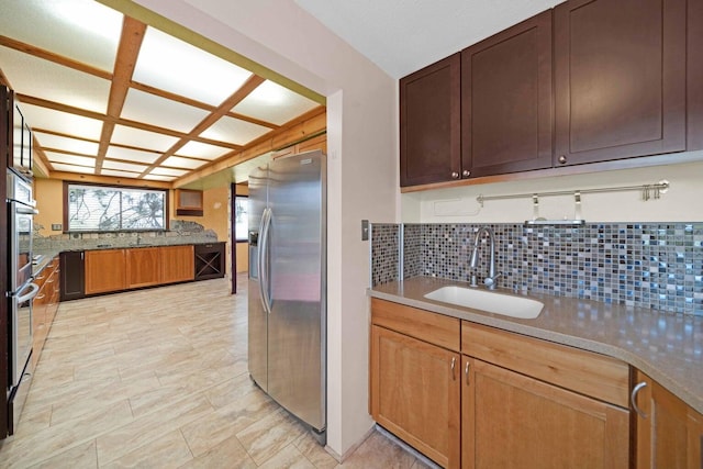 kitchen with sink, stainless steel fridge with ice dispenser, and tasteful backsplash