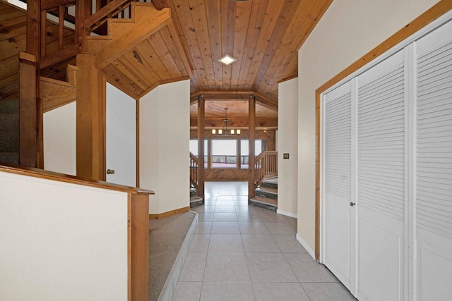 corridor featuring light tile patterned floors, lofted ceiling, and wood ceiling