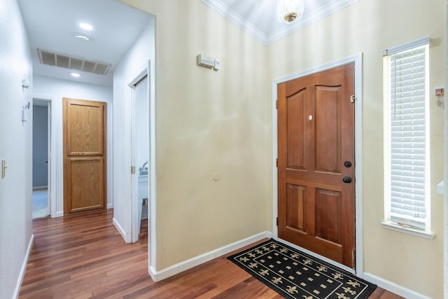 entryway featuring crown molding and dark hardwood / wood-style flooring