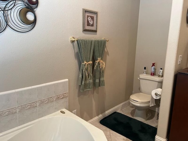 bathroom with tile patterned flooring, toilet, and a bathtub