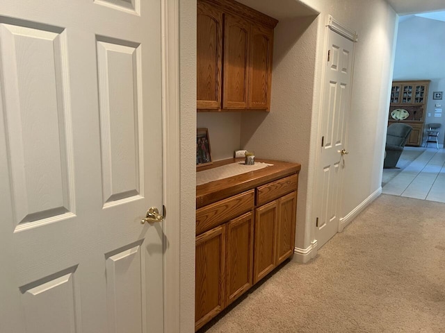 hallway with light colored carpet