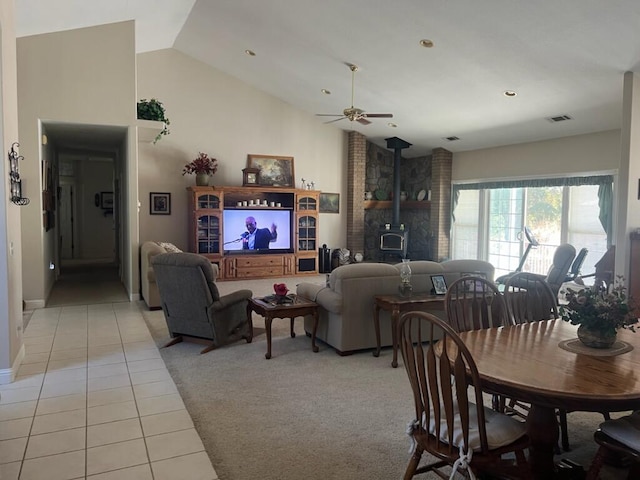 tiled living room with ceiling fan and vaulted ceiling