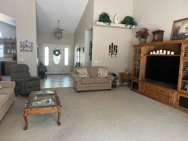 living room featuring high vaulted ceiling and carpet