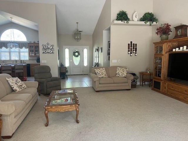 carpeted living room featuring lofted ceiling and an inviting chandelier