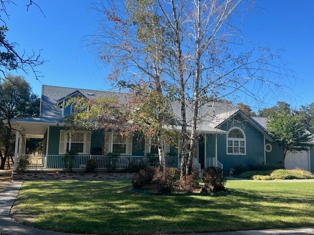 view of front of property with a porch and a front yard