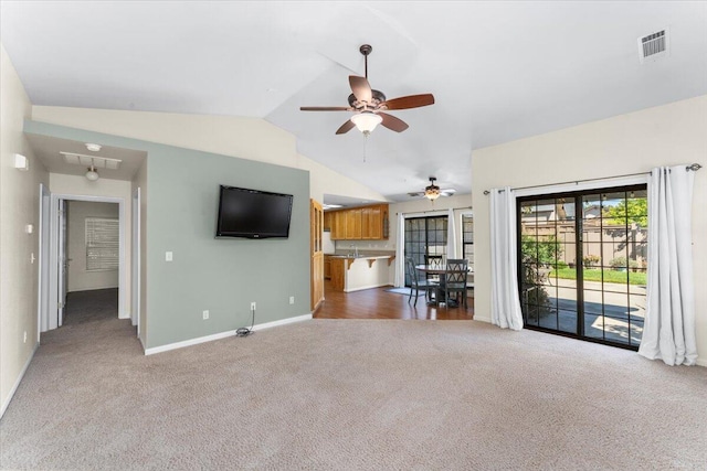 unfurnished living room featuring carpet flooring, ceiling fan, and vaulted ceiling