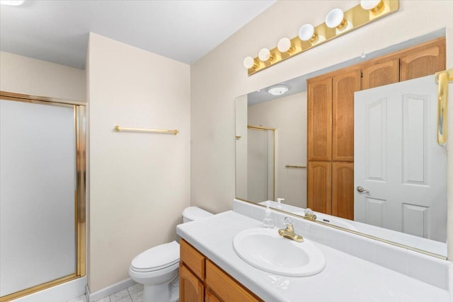 bathroom with toilet, vanity, tile patterned floors, and a shower with shower door