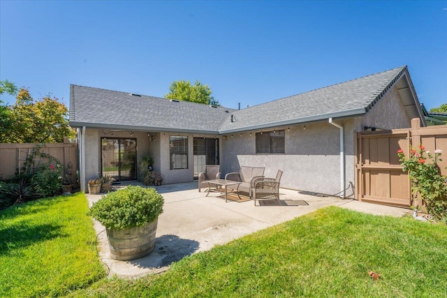 rear view of property featuring a patio area and a yard