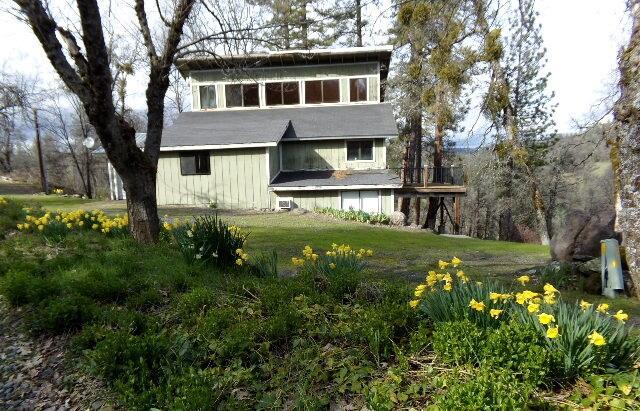 rear view of property with a lawn