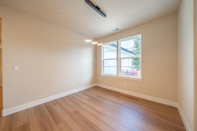 unfurnished room with light wood-type flooring