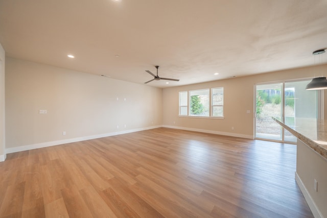 spare room featuring ceiling fan and light hardwood / wood-style flooring