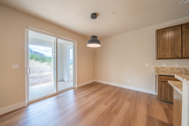 unfurnished dining area featuring light hardwood / wood-style flooring