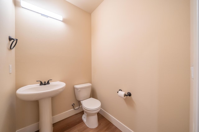 1132 Kellinger St, Redding, CA 96003 - bathroom featuring toilet, baseboards, and wood finished floors
