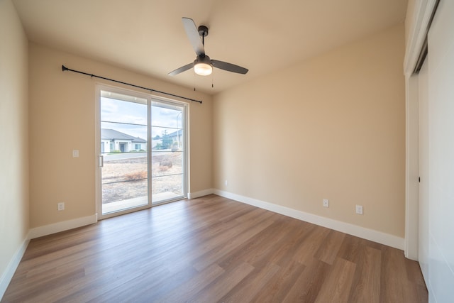 spare room with light wood-type flooring and ceiling fan