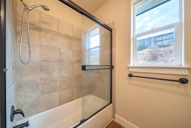 1132 Kellinger St, Redding, CA 96003 - bathroom with a wealth of natural light, baseboards, and bath / shower combo with glass door