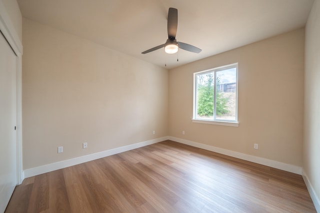 unfurnished bedroom featuring a closet, light wood-type flooring, and ceiling fan