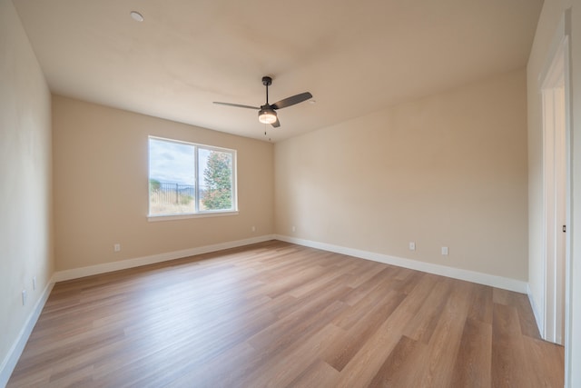 empty room featuring light hardwood / wood-style floors and ceiling fan