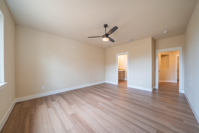 unfurnished bedroom featuring ceiling fan, light hardwood / wood-style flooring, and ensuite bath