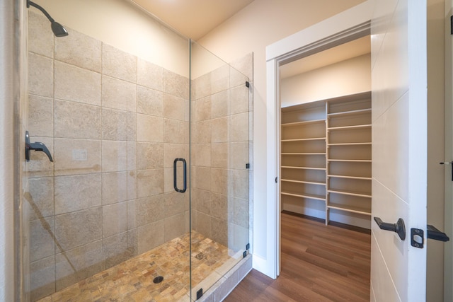 1132 Kellinger St, Redding, CA 96003 - full bath with a walk in closet, wood finished floors, and a stall shower