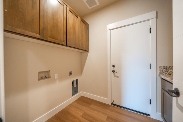 washroom featuring washer hookup, cabinets, light wood-type flooring, and electric dryer hookup