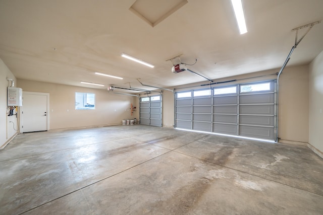 garage featuring a garage door opener and tankless water heater