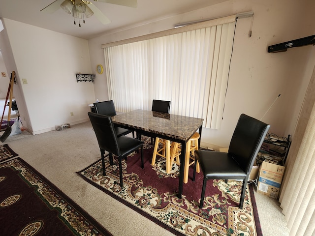 dining area featuring carpet flooring and ceiling fan