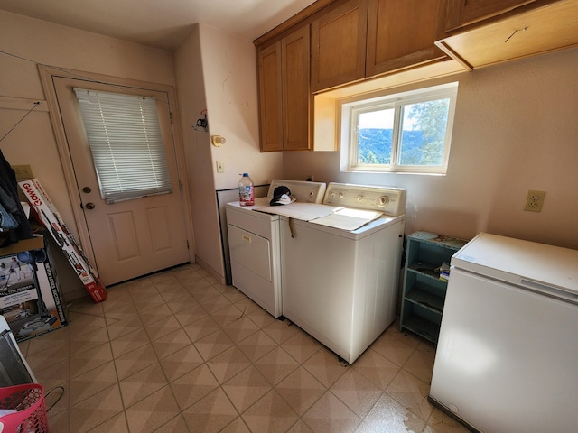 laundry area featuring cabinets and washer and clothes dryer