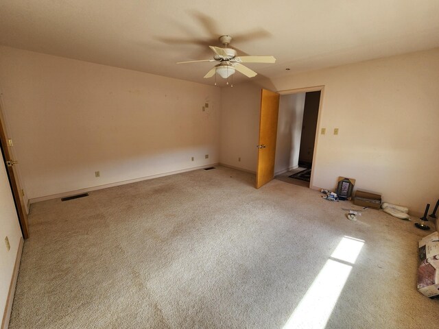 unfurnished bedroom with ceiling fan and light colored carpet