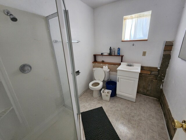 bathroom with vanity, toilet, and an enclosed shower