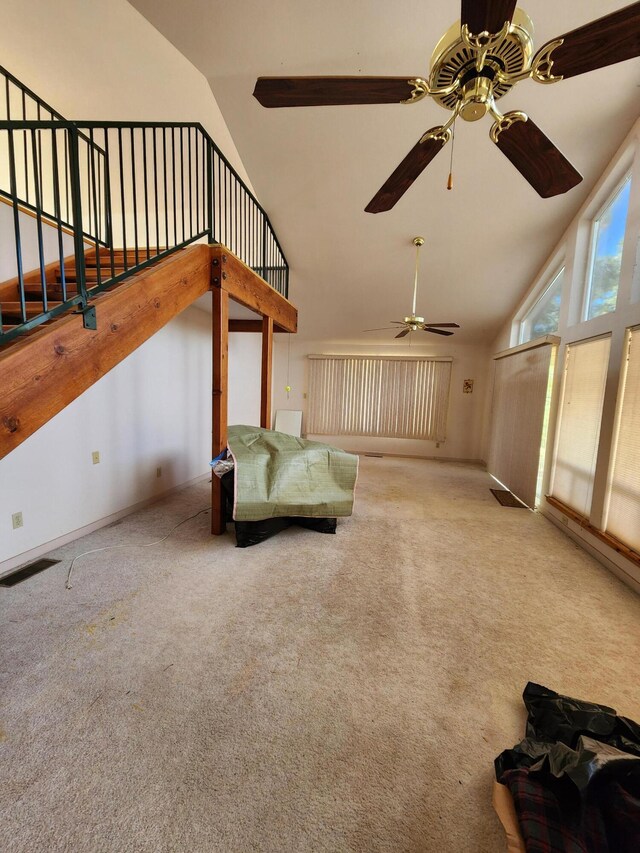 interior space featuring carpet, ceiling fan, and high vaulted ceiling