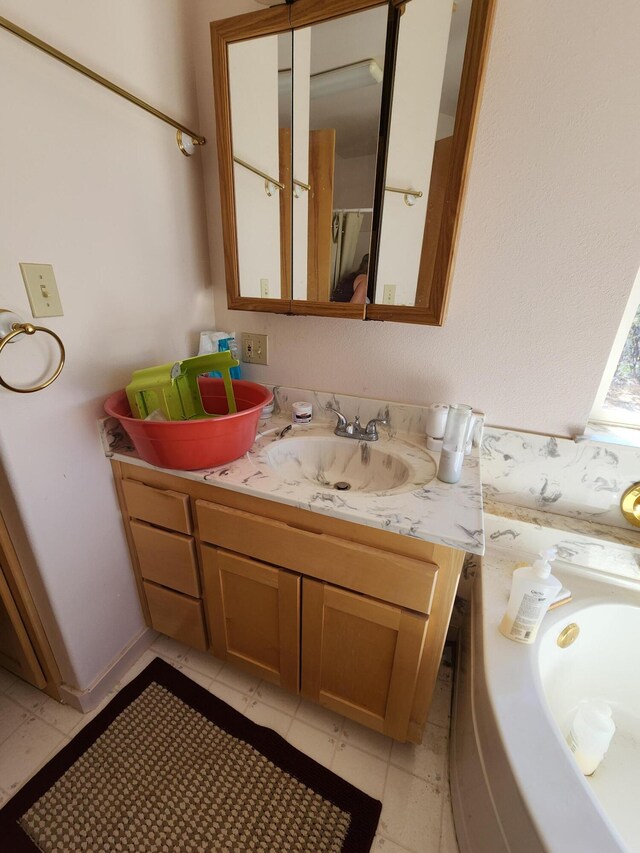 bathroom with tile patterned flooring and vanity