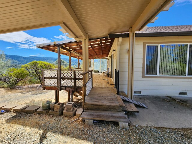 view of patio featuring a deck with mountain view