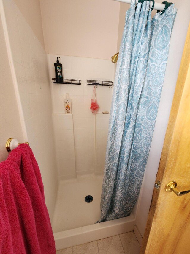 bathroom with tile patterned flooring and a shower with curtain