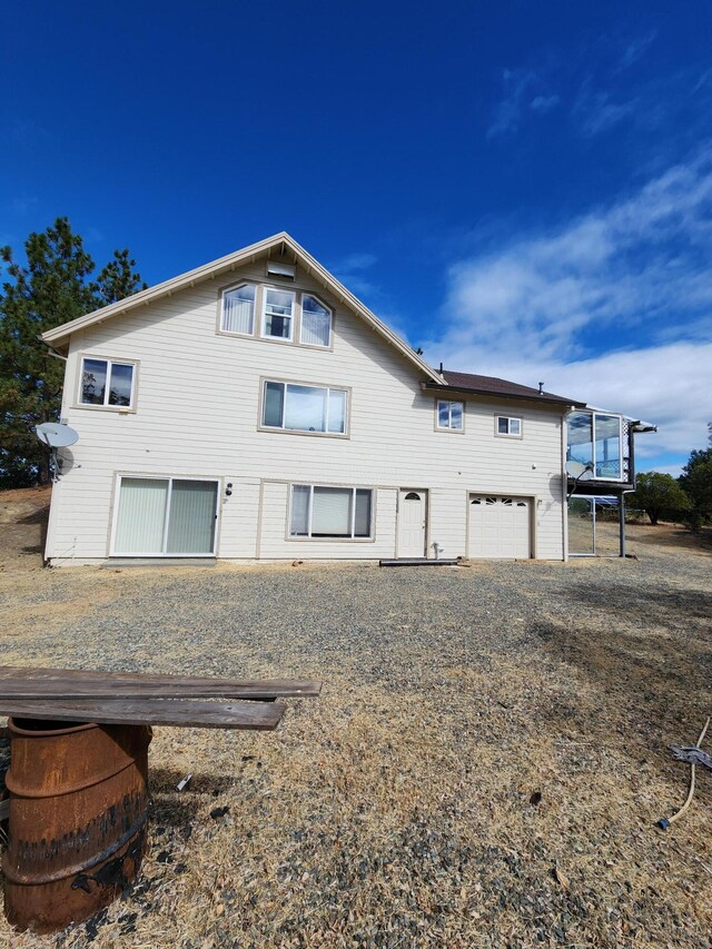 back of property with a garage