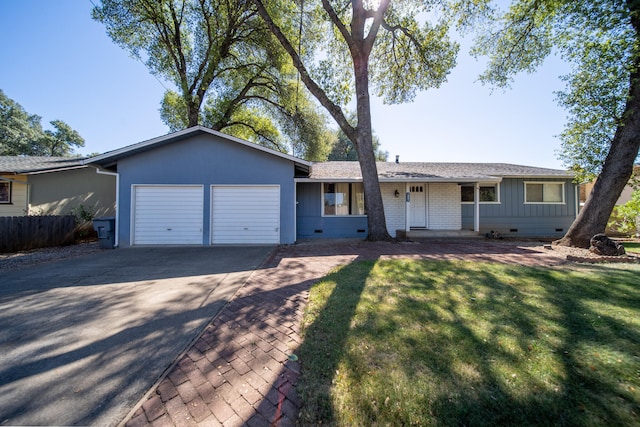 single story home featuring a garage and a front yard