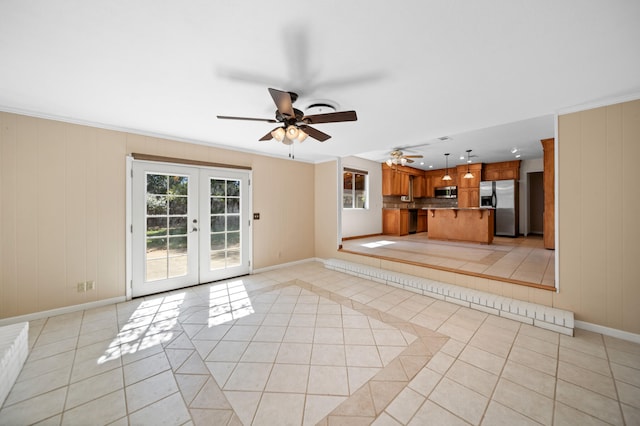 unfurnished living room featuring french doors, crown molding, light tile patterned floors, and ceiling fan