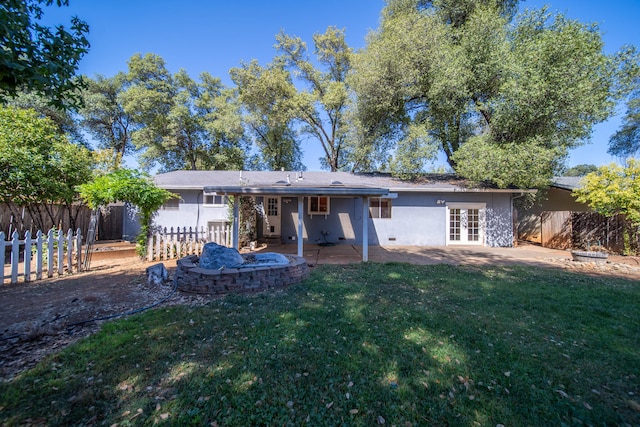 back of property featuring a patio and a lawn