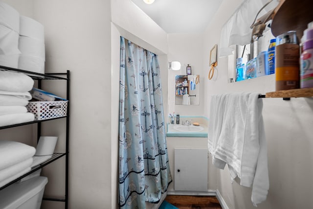 bathroom with hardwood / wood-style floors, vanity, and toilet