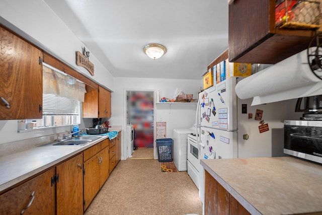 kitchen with washer / clothes dryer and sink