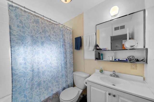 bathroom with walk in shower, vanity, and toilet