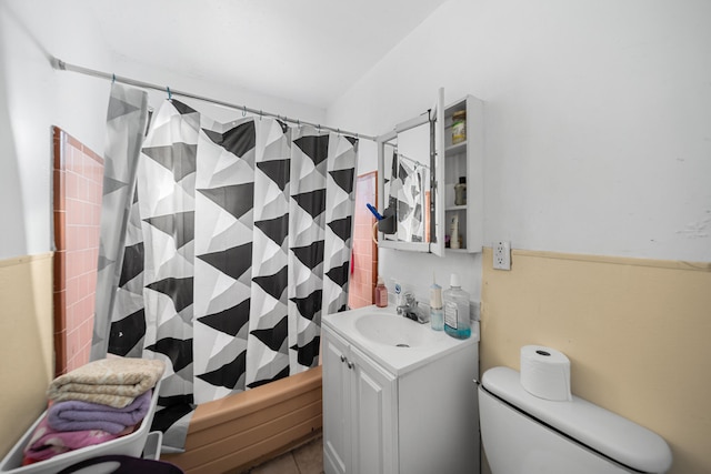 full bathroom featuring shower / tub combo, tile patterned flooring, vanity, and toilet