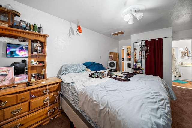 bedroom featuring carpet, ceiling fan, and ensuite bathroom