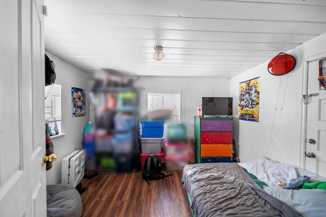 bedroom featuring wood-type flooring and heating unit