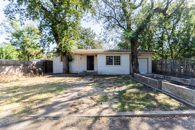 ranch-style home featuring a garage