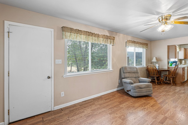 sitting room featuring ceiling fan and light wood-type flooring