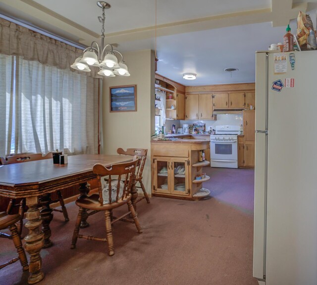 dining room featuring an inviting chandelier and carpet flooring