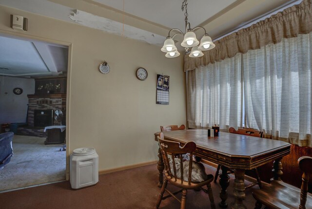 carpeted dining room featuring a notable chandelier