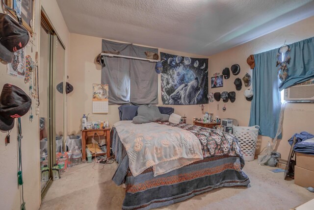 bedroom featuring a textured ceiling and a closet