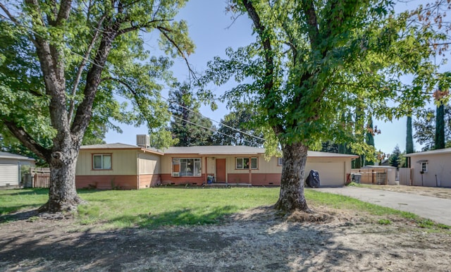 ranch-style house featuring central AC unit, a front yard, and a garage